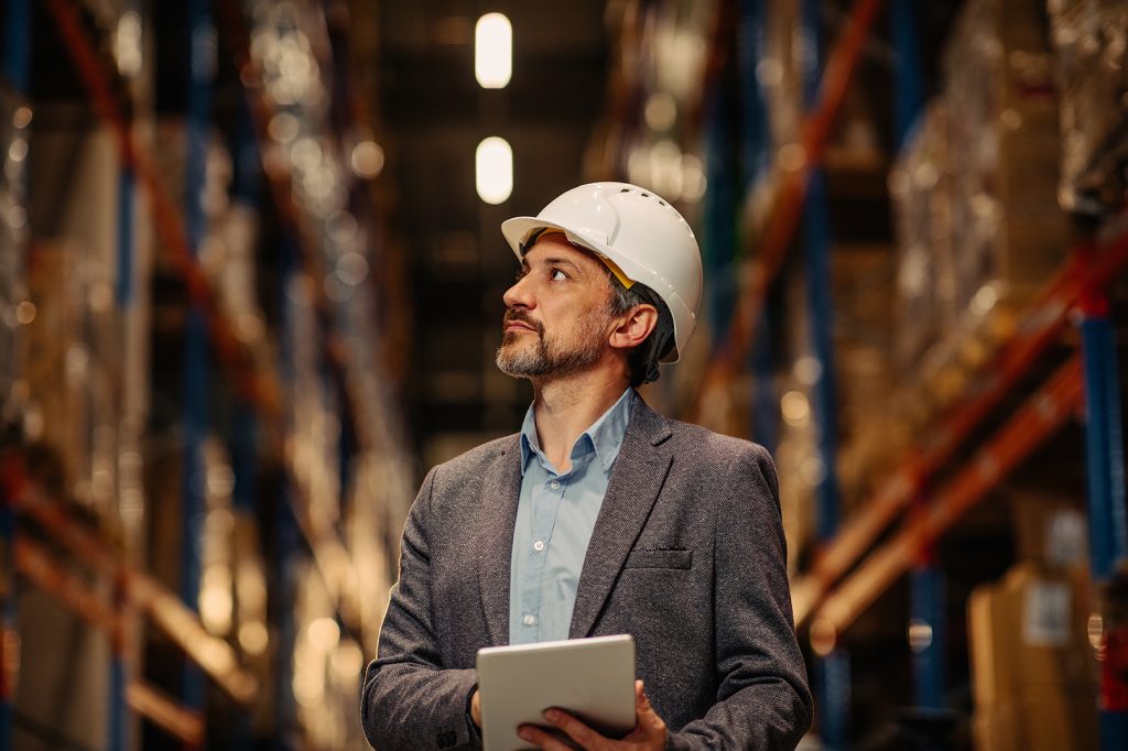 Warehouses,Manager,Looking,Over,The,Inventory.,He,Is,Using,Digital